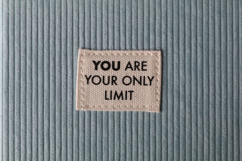 Fabric patch on blue velvet with motivational text 'You Are Your Only Limit' in close-up view.